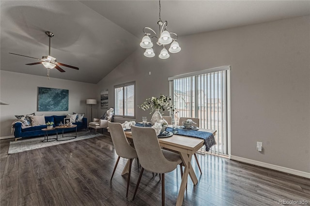 dining area with ceiling fan with notable chandelier, dark hardwood / wood-style floors, and vaulted ceiling