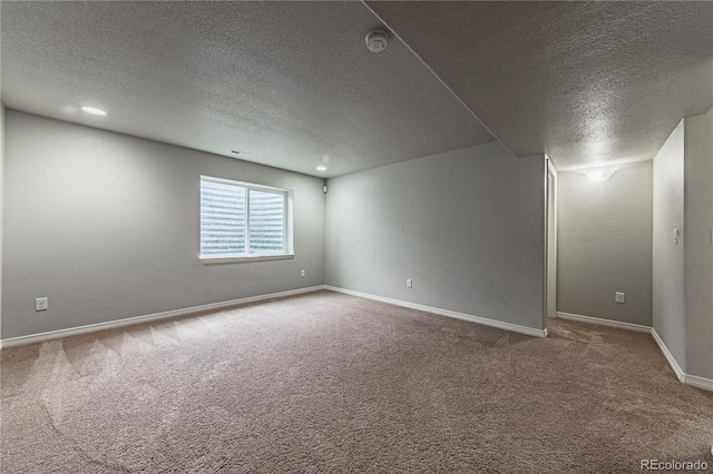 carpeted empty room with a textured ceiling