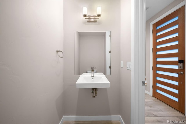 bathroom featuring wood-type flooring and sink