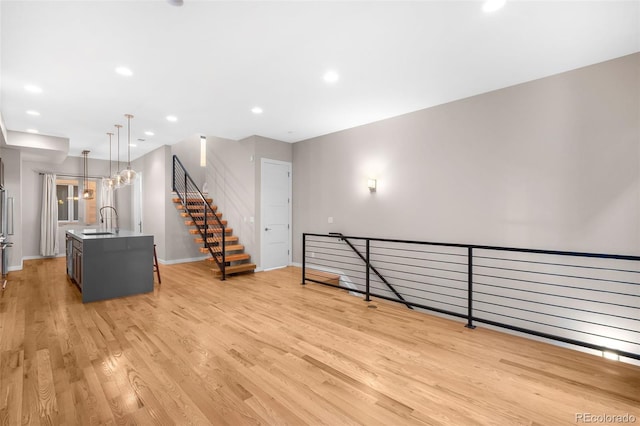 interior space featuring sink and light hardwood / wood-style flooring