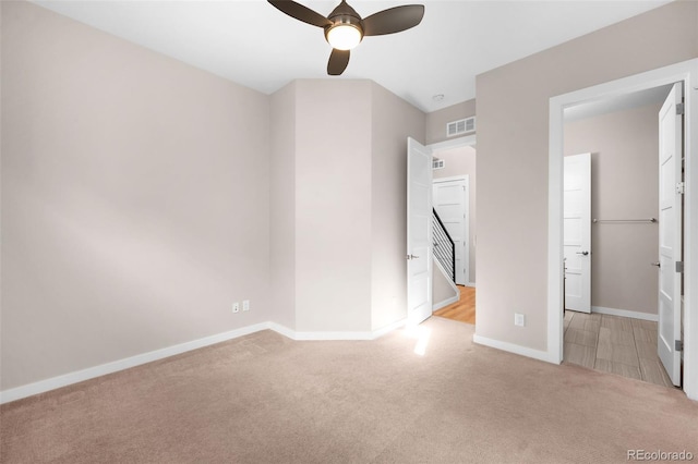 interior space featuring light carpet and ceiling fan