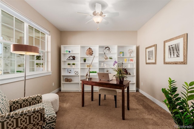 carpeted office with ceiling fan and a wealth of natural light