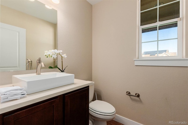 bathroom featuring vanity and toilet