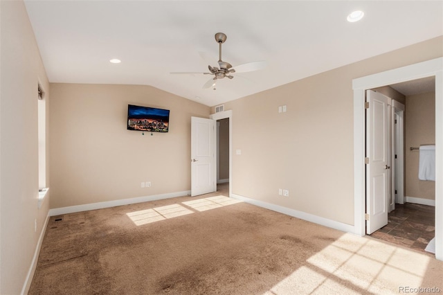 unfurnished bedroom featuring lofted ceiling, light colored carpet, and ceiling fan