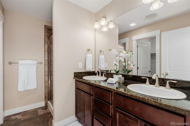 bathroom featuring vanity and a shower with shower door