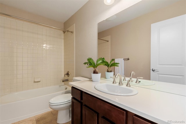 full bathroom with vanity, toilet, tile patterned flooring, and tiled shower / bath combo