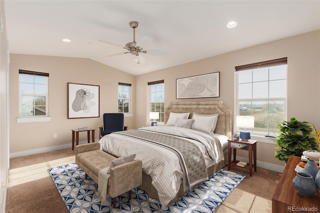 bedroom featuring ceiling fan, light colored carpet, multiple windows, and lofted ceiling