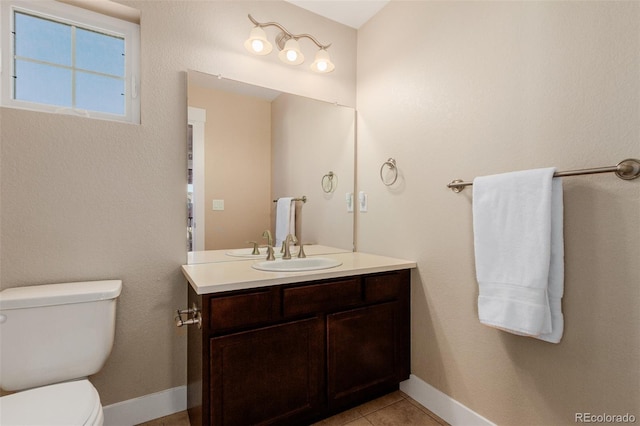 bathroom with vanity, toilet, and tile patterned floors