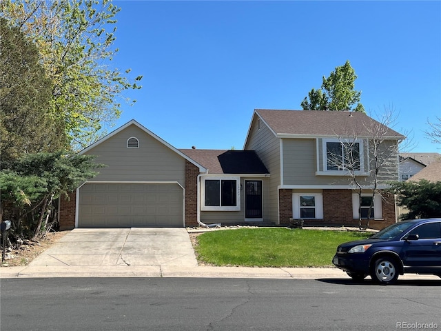 15962 E Exposition Dr, Aurora, CO 80017 - split level home featuring brick siding, a garage, concrete driveway, and a front yard
