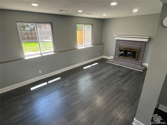 15962 E Exposition Dr, Aurora, CO 80017 - unfurnished living room featuring dark wood-style floors, recessed lighting, and a fireplace