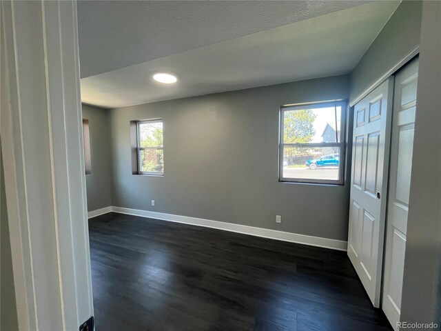 15962 E Exposition Dr, Aurora, CO 80017 - spare room with dark wood-type flooring and recessed lighting