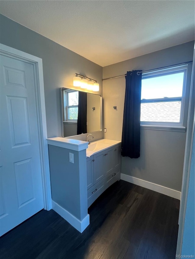 15962 E Exposition Dr, Aurora, CO 80017 - bathroom with wood finished floors, vanity, and healthy amount of natural light