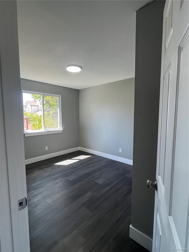 15962 E Exposition Dr, Aurora, CO 80017 - empty room featuring baseboards and dark wood-type flooring