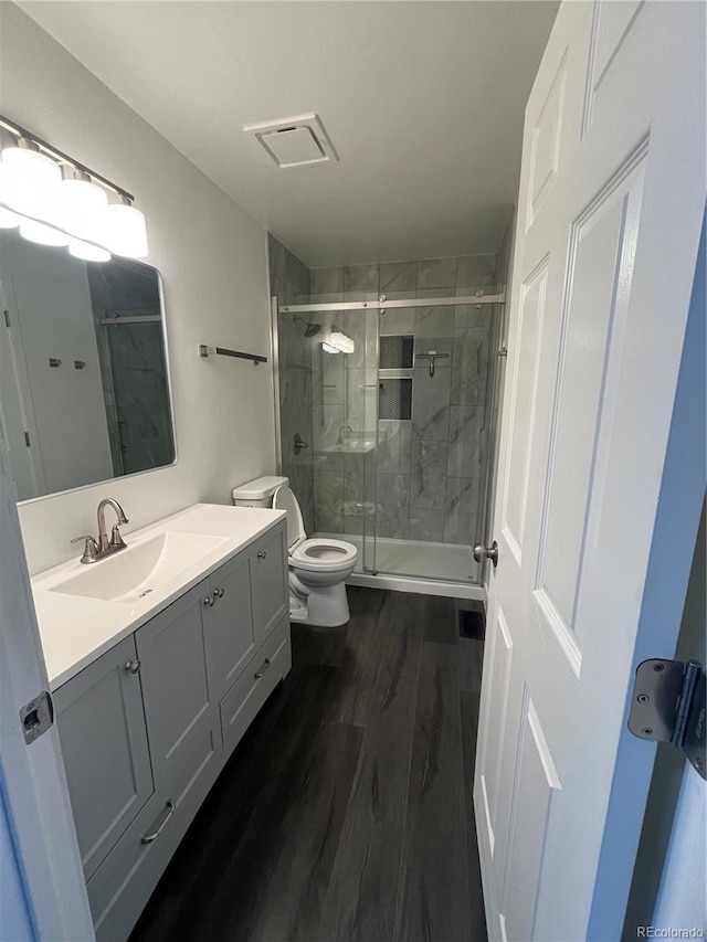 15962 E Exposition Dr, Aurora, CO 80017 - full bathroom featuring vanity, wood finished floors, and a stall shower
