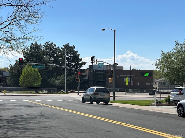15962 E Exposition Dr, Aurora, CO 80017 - view of asphalt road featuring traffic lights, sidewalks, curbs, and street lighting