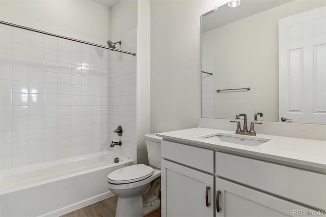 full bathroom with shower / tub combination, toilet, vanity, and hardwood / wood-style flooring