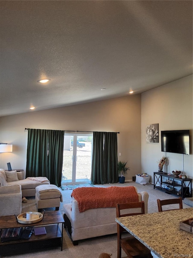 living room featuring carpet flooring, a textured ceiling, and vaulted ceiling