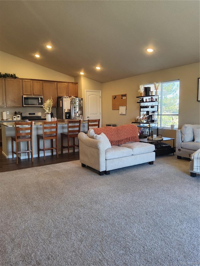 living room featuring carpet flooring and vaulted ceiling