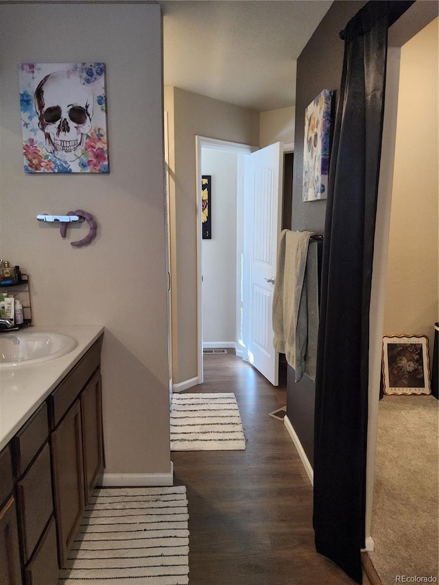 bathroom featuring vanity and hardwood / wood-style flooring