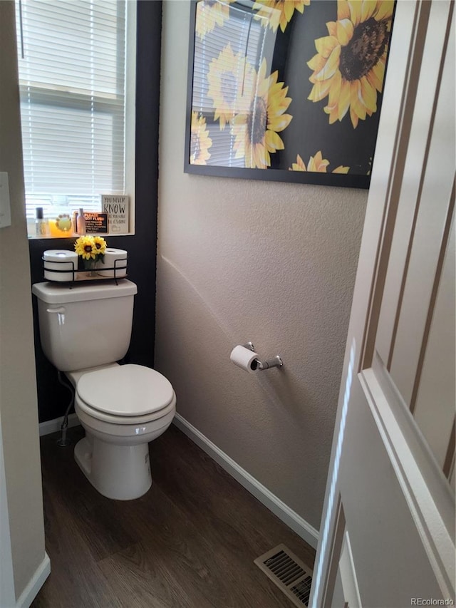 bathroom with wood-type flooring and toilet