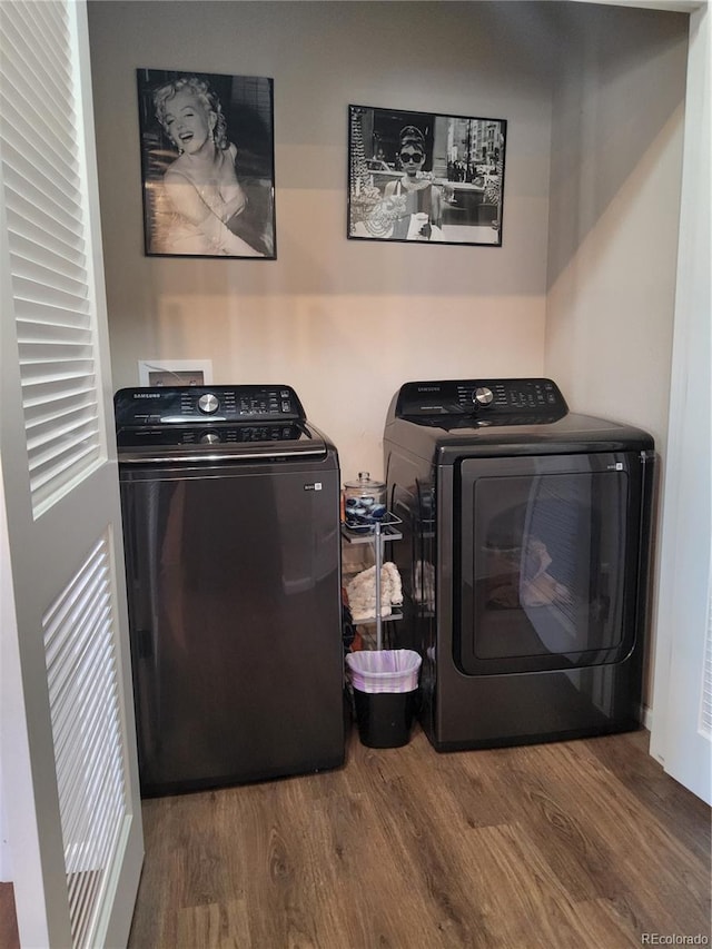 laundry area with dark hardwood / wood-style flooring and washer and clothes dryer