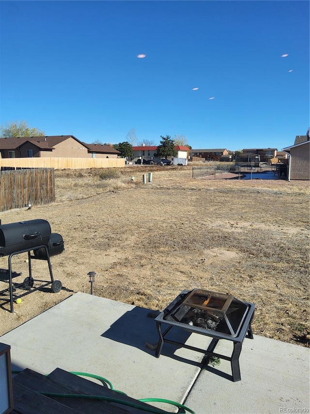 view of yard with a patio and a fire pit