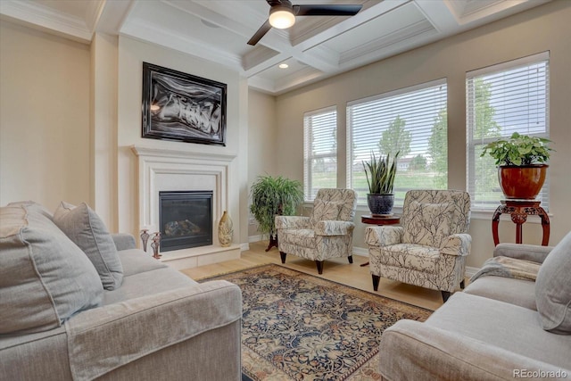 living room with hardwood / wood-style floors, coffered ceiling, crown molding, ceiling fan, and beam ceiling