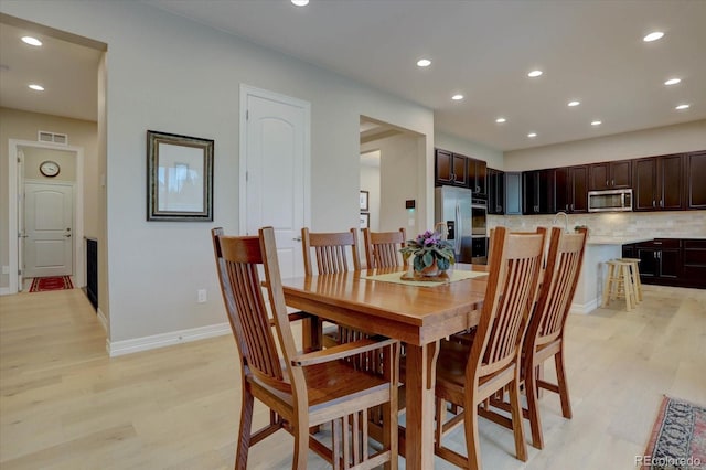 dining space with light hardwood / wood-style floors