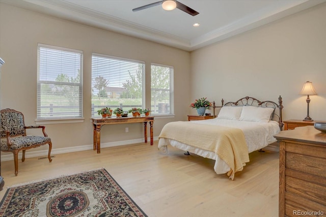 bedroom with hardwood / wood-style floors, crown molding, and ceiling fan