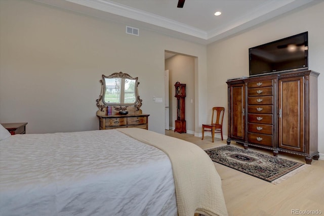 bedroom with ceiling fan, ornamental molding, and light wood-type flooring