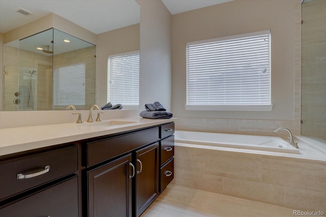 bathroom with vanity and independent shower and bath