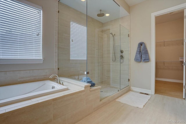 bathroom with separate shower and tub