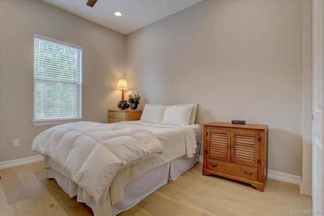 bedroom with ceiling fan and light hardwood / wood-style flooring