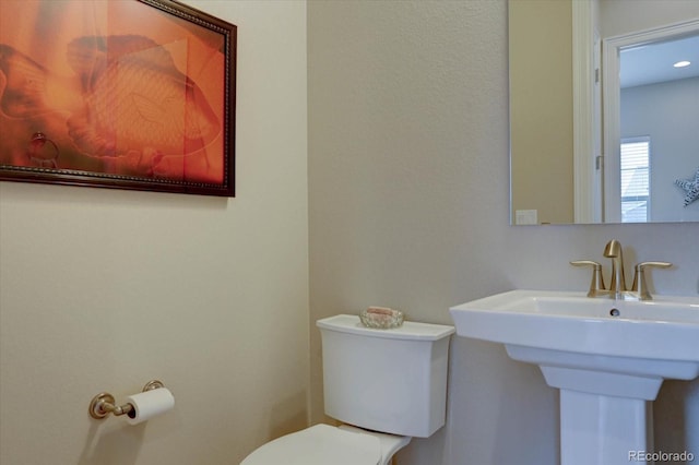 bathroom featuring sink and toilet