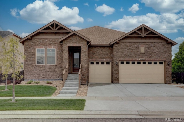 craftsman house with a garage and a front yard