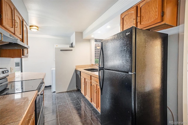 1625 Larimer St Unit 605, Denver, CO 80202 - kitchen with black appliances, under cabinet range hood, brown cabinetry, washer / clothes dryer, and light countertops