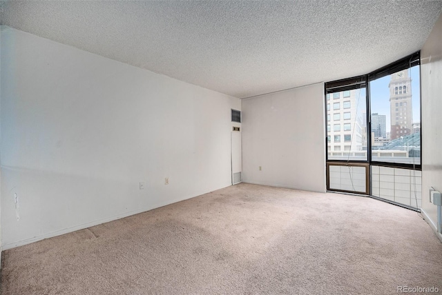 1625 Larimer St Unit 605, Denver, CO 80202 - empty room with carpet, a view of city, a textured ceiling, and expansive windows