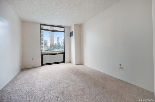 1625 Larimer St Unit 605, Denver, CO 80202 - spare room with carpet flooring, a textured ceiling, a view of city, and a wall of windows
