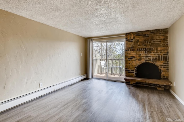 1300 S Parker Rd Unit 9, Denver, CO 80231 - unfurnished living room with wood finished floors, a textured ceiling, a baseboard radiator, a brick fireplace, and baseboards