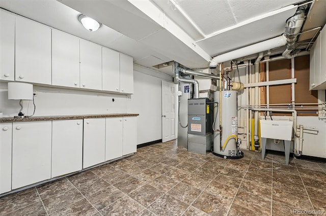 7751 S Race St, Centennial, CO 80122 - finished basement with water heater, heating unit, dark stone finish flooring, and baseboards
