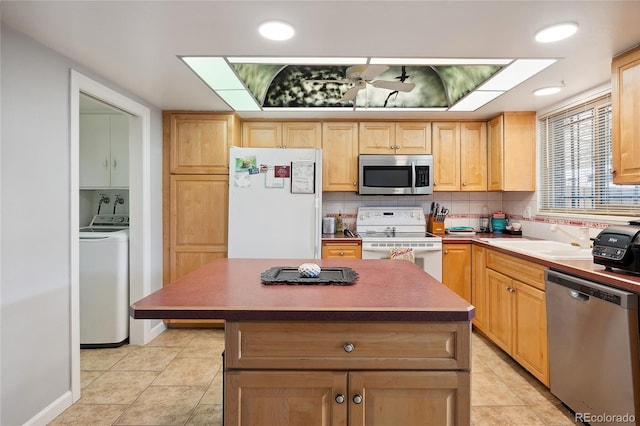 9019 E Oxford Dr, Denver, CO 80237 - kitchen featuring stainless steel appliances, washer / clothes dryer, light brown cabinetry, a sink, and light tile patterned floors