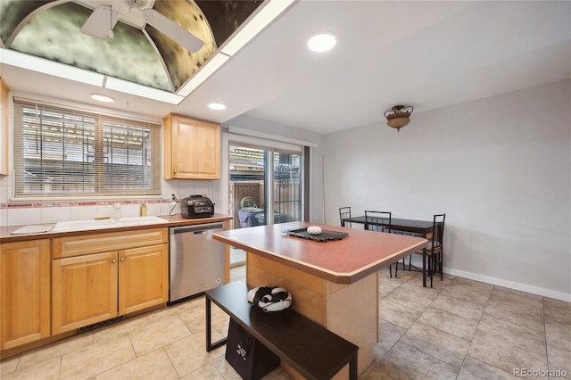 9019 E Oxford Dr, Denver, CO 80237 - kitchen with stainless steel dishwasher, a sink, light tile patterned flooring, light brown cabinets, and recessed lighting