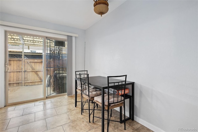 9019 E Oxford Dr, Denver, CO 80237 - dining room featuring baseboards, tile patterned flooring, and lofted ceiling