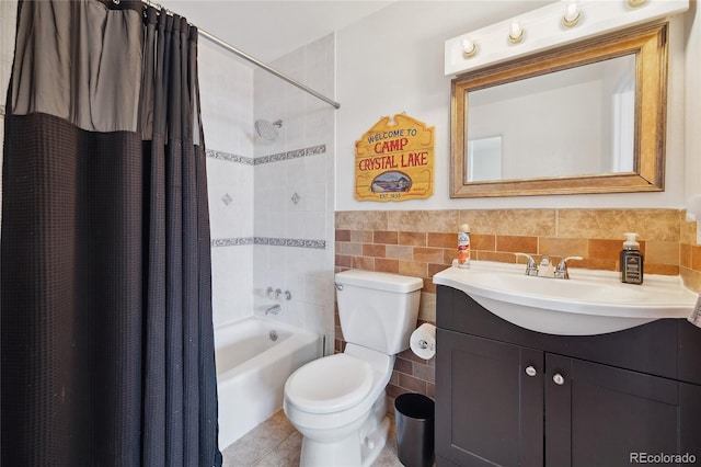 9019 E Oxford Dr, Denver, CO 80237 - bathroom featuring tile walls, shower / bath combo with shower curtain, vanity, toilet, and wainscoting