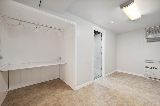 9019 E Oxford Dr, Denver, CO 80237 - finished basement featuring baseboards, track lighting, and light tile patterned floors