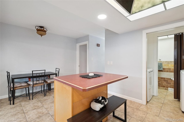 9019 E Oxford Dr, Denver, CO 80237 - kitchen featuring a center island, light tile patterned floors, baseboards, a skylight, and recessed lighting