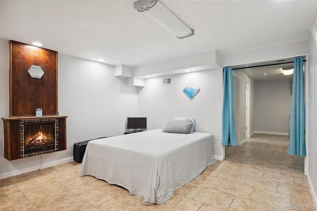 9019 E Oxford Dr, Denver, CO 80237 - bedroom featuring recessed lighting, a warm lit fireplace, and baseboards