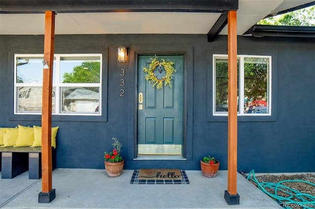 332 Maple Dr, Frederick, CO 80530 - view of exterior entry with stucco siding and a porch