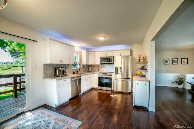 332 Maple Dr, Frederick, CO 80530 - kitchen with stainless steel appliances, light countertops, dark wood-style flooring, and white cabinets