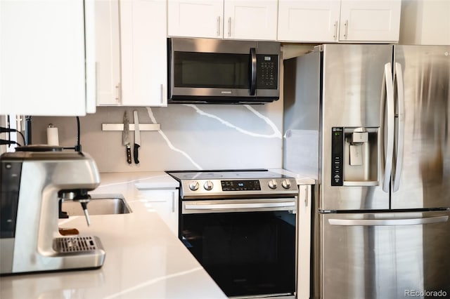 332 Maple Dr, Frederick, CO 80530 - kitchen featuring stainless steel appliances, light countertops, and white cabinets